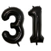 A set of two black foil balloons shaped like the number 3 and the number 1.