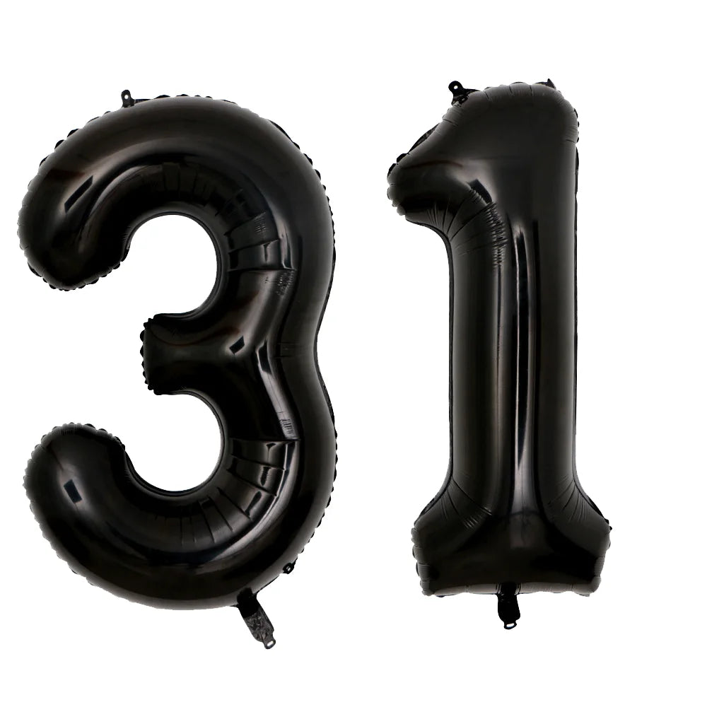 A set of two black foil balloons shaped like the number 3 and the number 1.