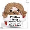 A handmade crochet doll with brown hair and a white face, holding a card that reads Positive Jesus Forever and always my love
