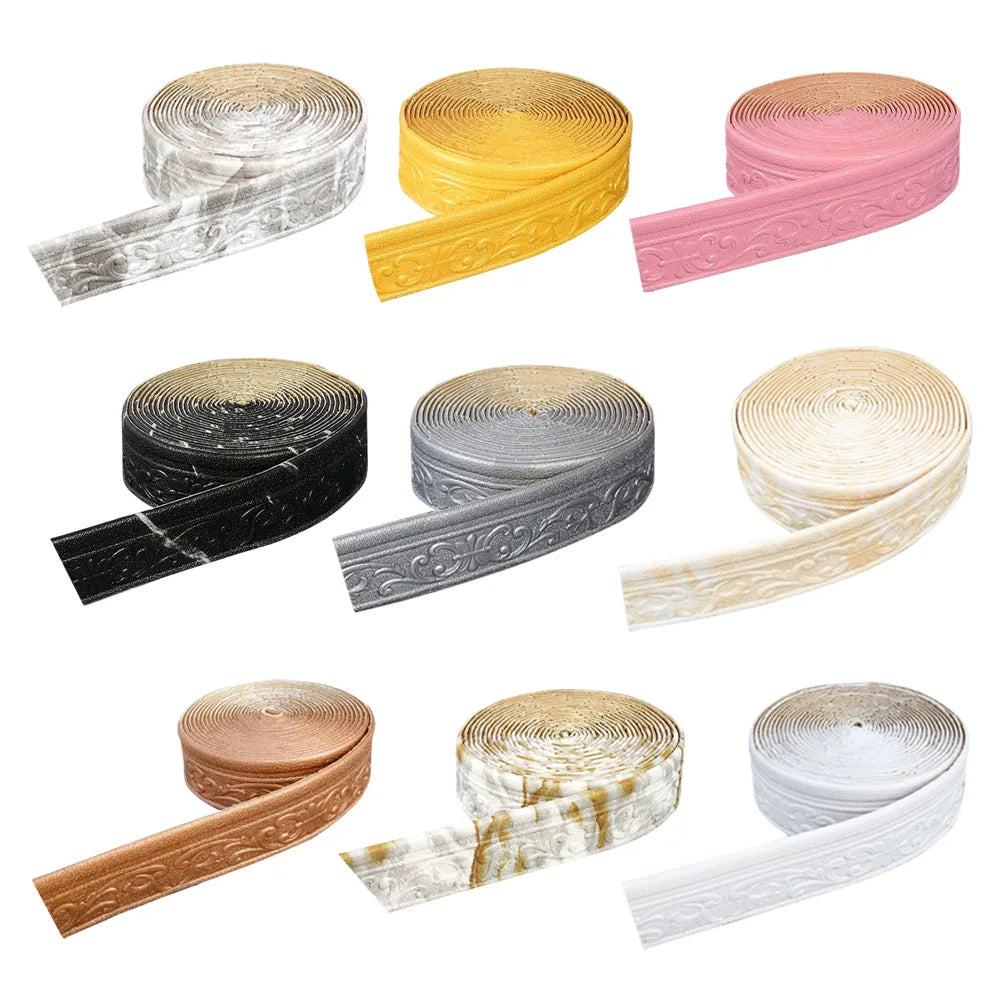 Rolls of 3D self-adhesive wall trim border in various colors including silver, yellow, pink, black, and natural wood tones