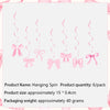 A set of pink hanging spin bow cupcake toppers for birthday and bridal shower decorations.