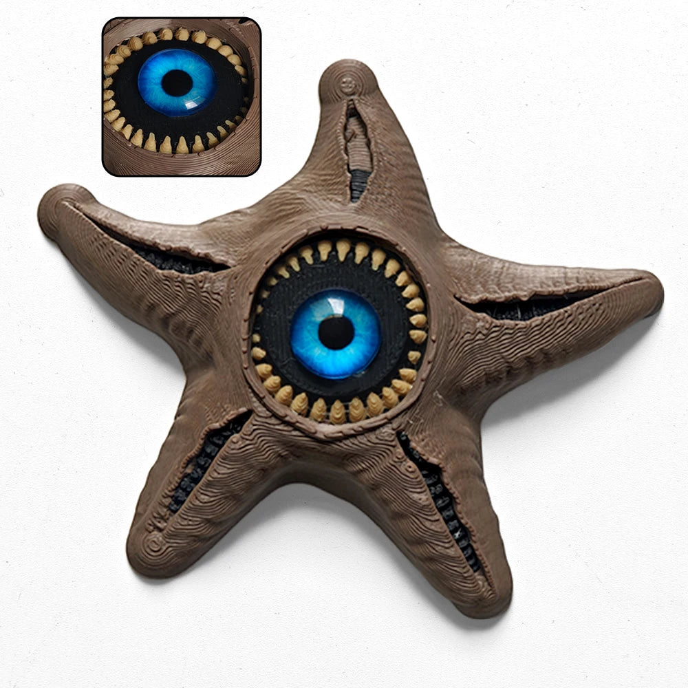 A brown, starfish-shaped fidget toy with a large blue eye design.