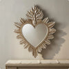 Ornate flame-shaped wall mirror with a heart cutout, featuring a distressed gold finish.