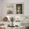 Framed canvas art featuring a misty countryside scene with spring flowers and trees hanging on a white wall.