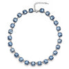 A silver-toned crystal pendant necklace featuring round blue gemstones connected by a chain.