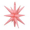 A cluster of pink star burst foil balloons with pointed tips.