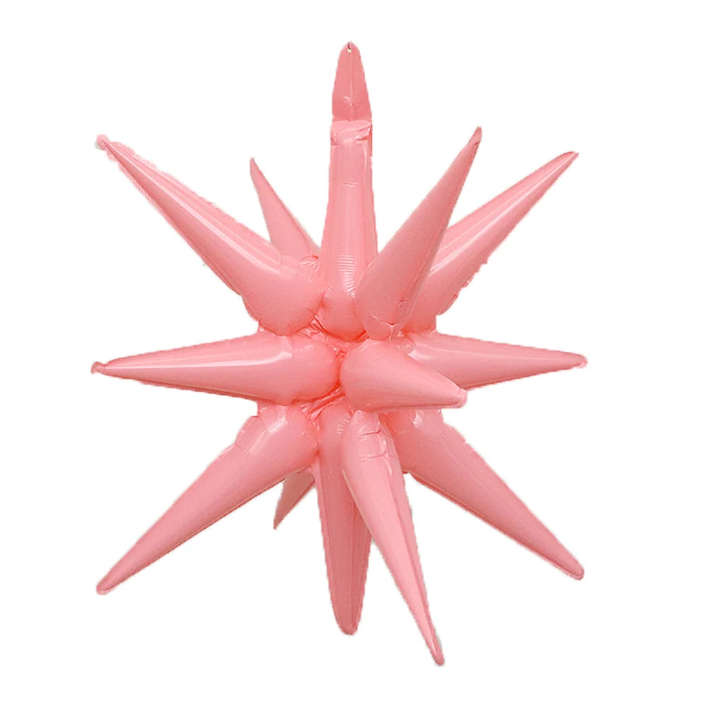 A cluster of pink star burst foil balloons with pointed tips.