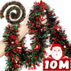 A hand is holding a festive Christmas tinsel garland made of red and green glittery strands.