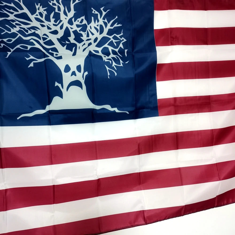 A decorative flag featuring a silhouette of a tree on a blue field and red and white stripes.