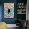 A framed canvas wall art featuring a black cat silhouette against a vibrant pink and green floral background.