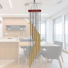 A hanging wind chime set featuring twelve tubes with gold and silver bells suspended from a wooden bar.