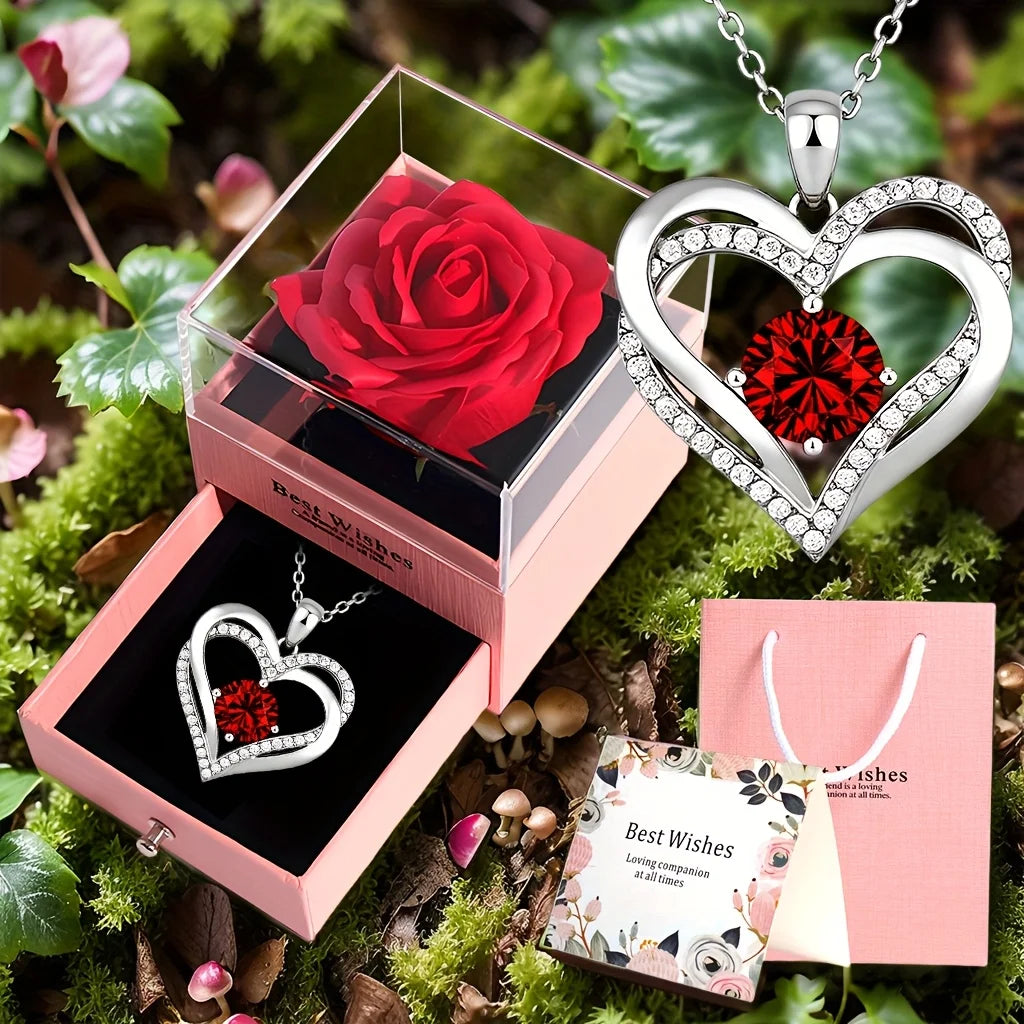 A gift set featuring a red rose, a heart pendant necklace, and a small pink box with a tag.