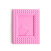 A pink mini film frame with a textured, diamond pattern for instant photos.