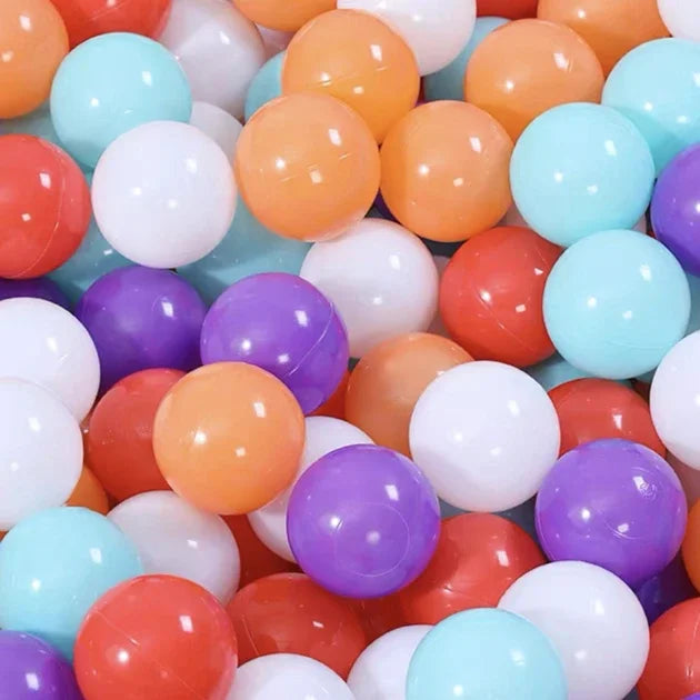 A collection of colorful, glossy, spherical plastic balls in shades of orange, pink, purple, and blue.