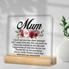 A personalized acrylic keepsake plaque with a wooden base featuring a floral design and a heartfelt message for Mom