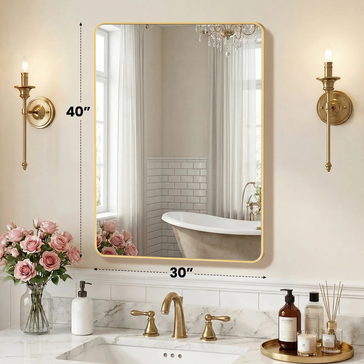 A modern wall mirror with a gold metal frame reflecting a bathroom interior and a bathtub.