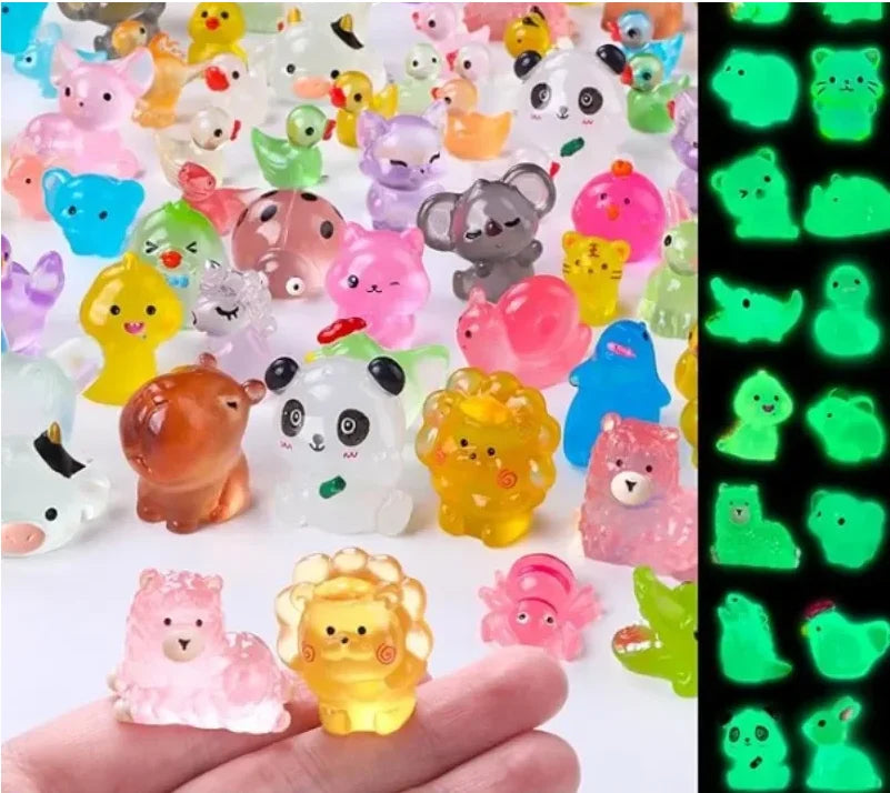 A collection of colorful luminous resin animal figurines, including cats, bears, and other creatures, displayed on a hand.
