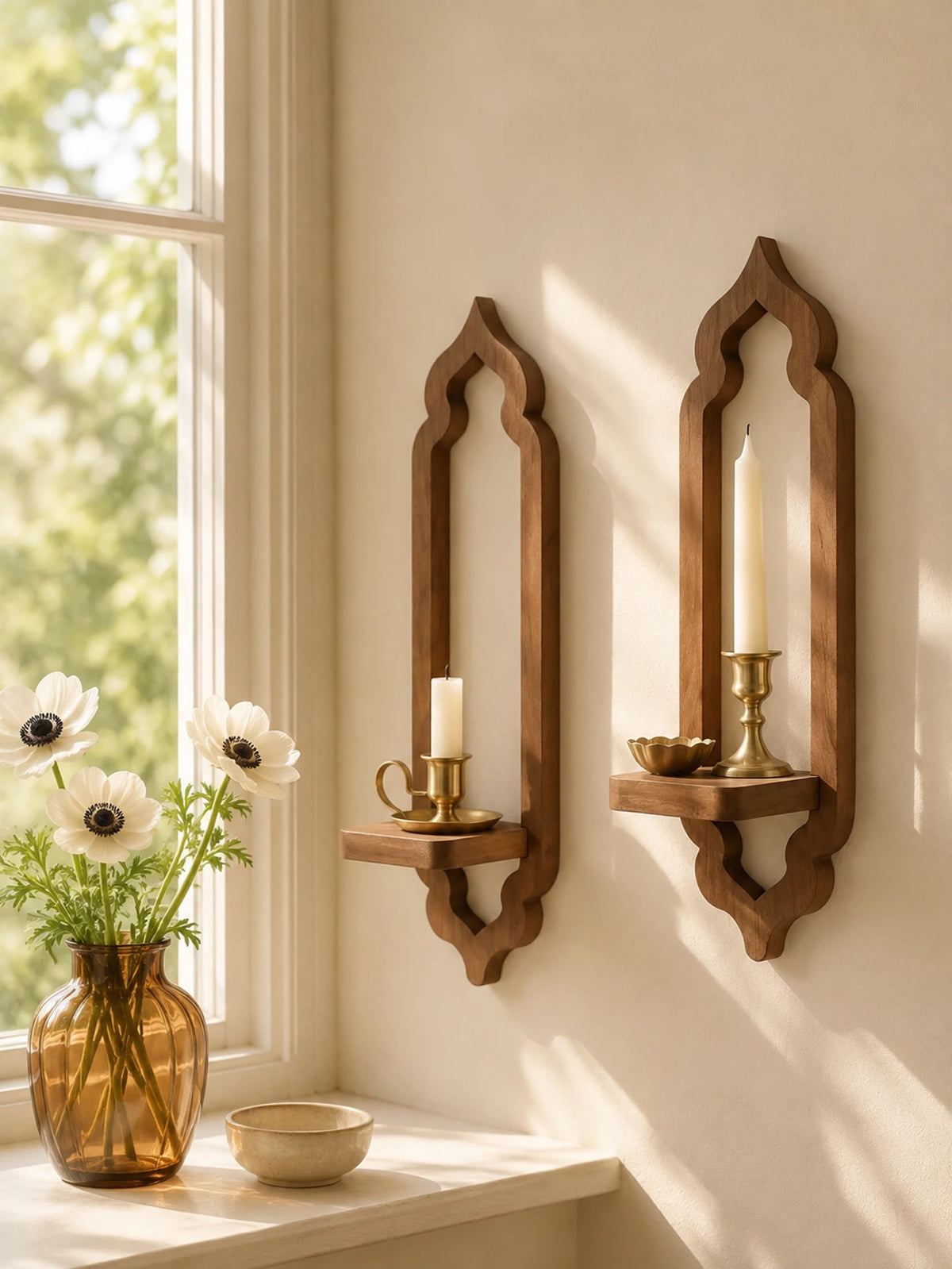 A rustic wooden arch wall shelf with a candle and small bowl displayed on a light-colored wall.