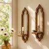 A rustic wooden arch wall shelf with a candle and small bowl displayed on a light-colored wall.