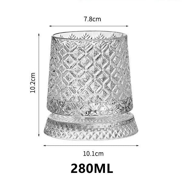 A clear crystal whiskey glass with a diamond relief pattern and a textured base.