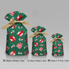 Festive Christmas drawstring gift bags in green fabric featuring red and white snowflake and Santa designs