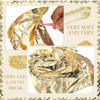 Close-up of edible gold leaf flakes being used for baking and cake decoration.