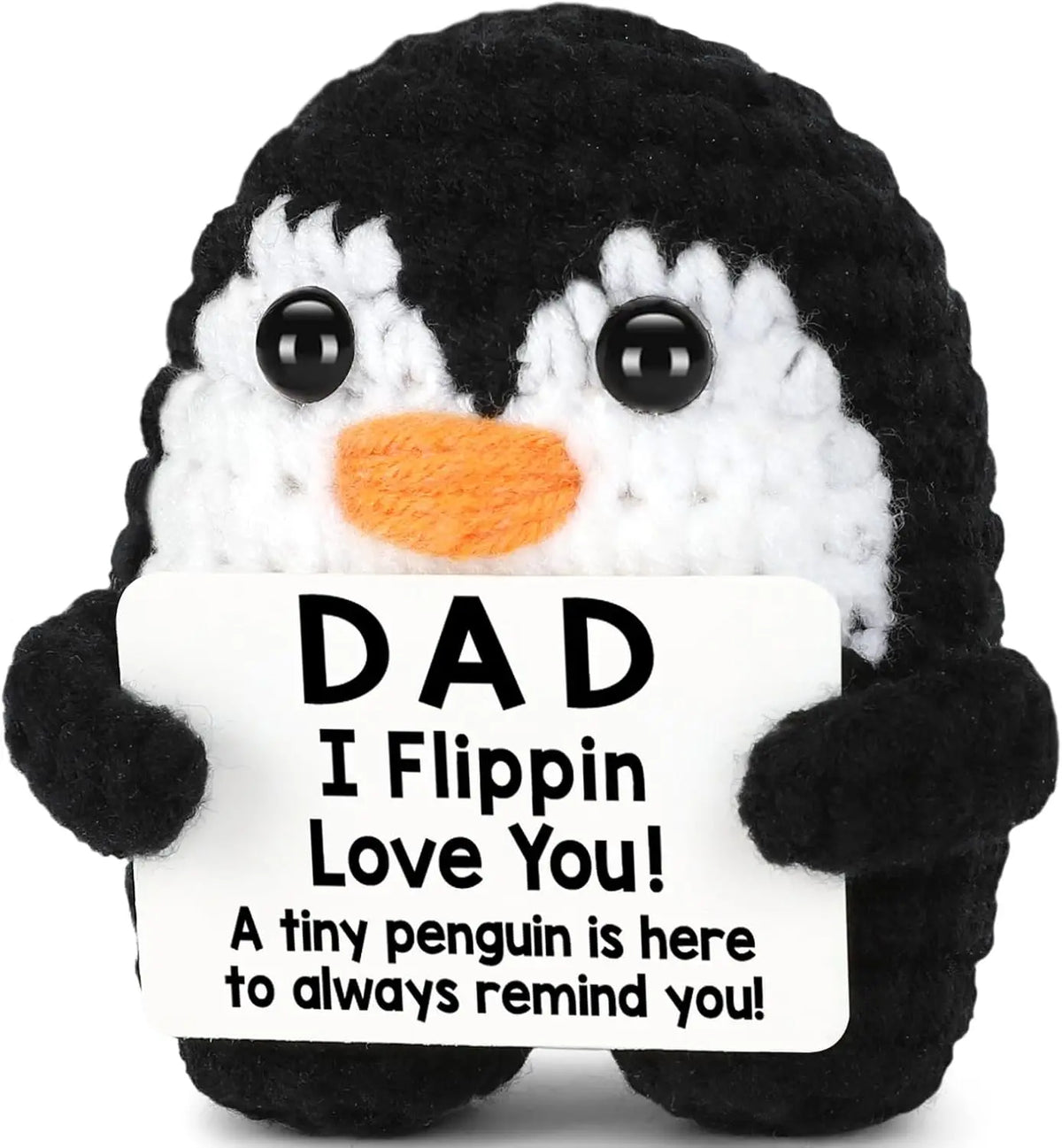 A black and white crochet penguin plush doll with a sign that reads Dad I Flippin Love You
