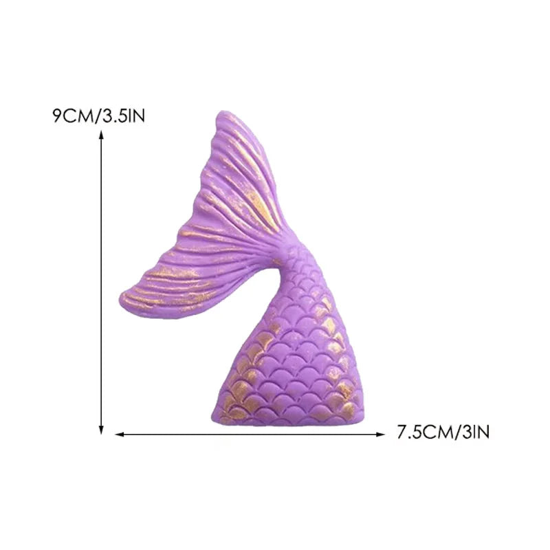 Purple mermaid tail cake topper featuring scales and a seashell decoration.