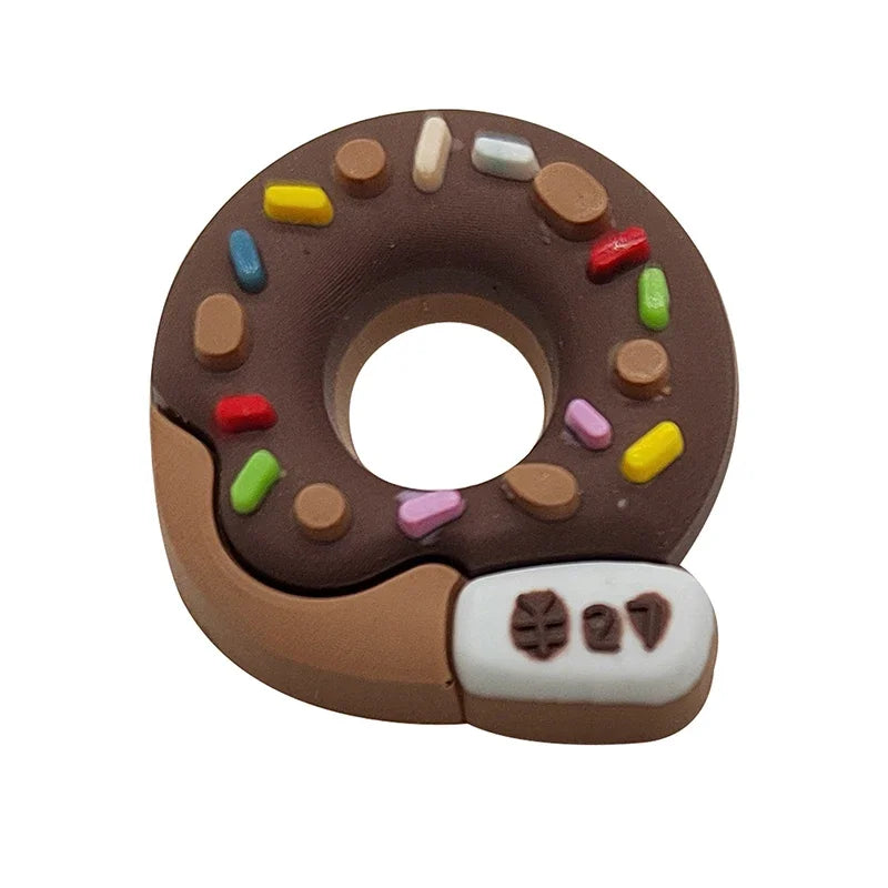 A brown doughnut shape decorated with small colored candies and a white shoe attached to the bottom.