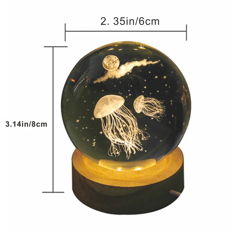 A glass crystal ball featuring a glowing jellyfish and stars, used as a night light.