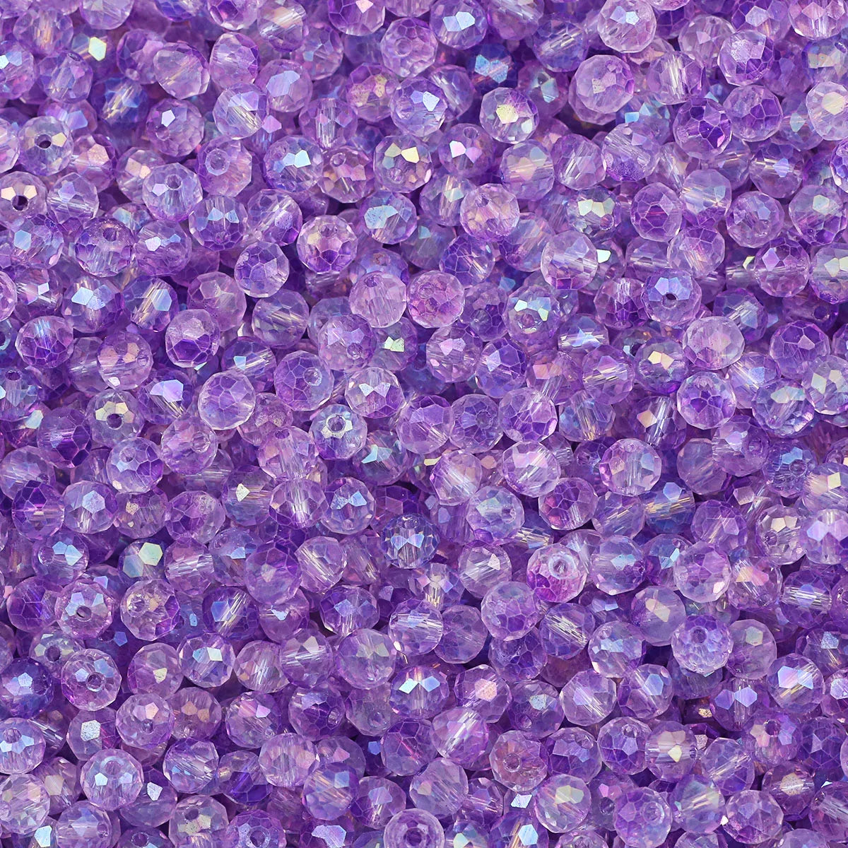 A close-up view of small, flat round purple AB crystal glass beads for jewelry making.