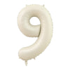 A large, beige foil number balloon shaped like the numeral 9.