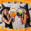 A woman shows off Halloween trick or treat candy bags with sturdy handles against a brick background.