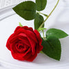A vibrant red velvet artificial rose with green leaves on a white background.