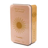 A vintage art tarot oracle card deck in a rose gold metal tin with a sun design.
