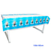 A long table covered with blue and white baby boss themed decorations and disposable tableware set.