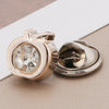 A pair of gold-toned pearl and rhinestone no-sew buttons for clothing and crafts