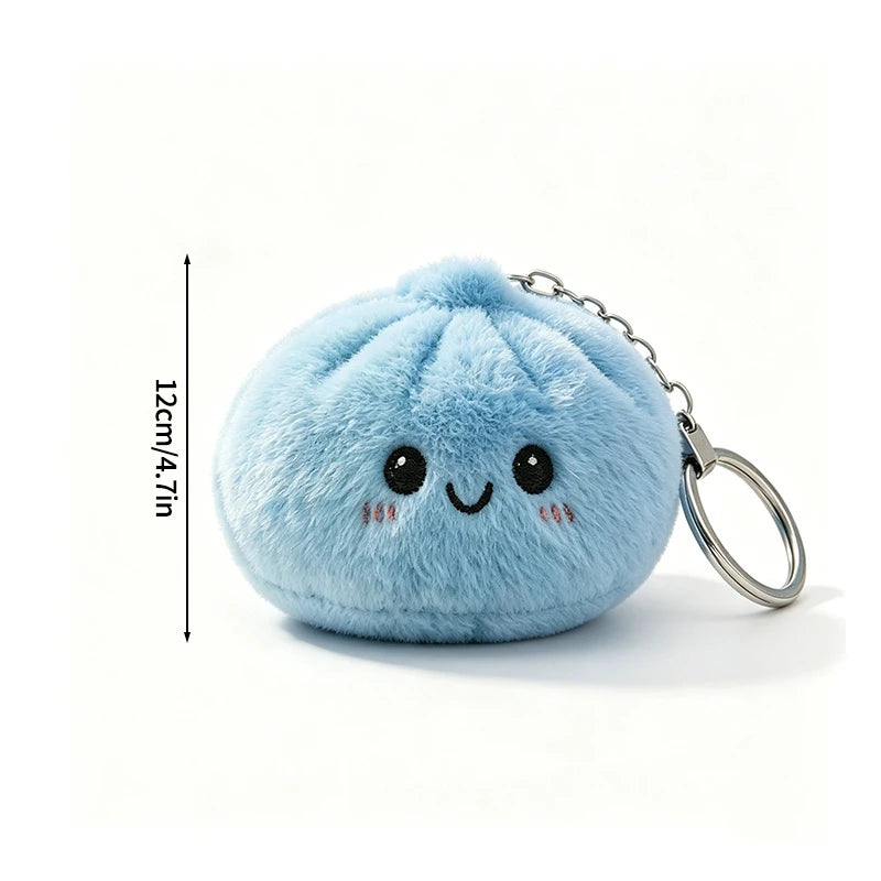 Light blue fluffy dumpling shaped squishy keychain with a silver ring and stitched eyes