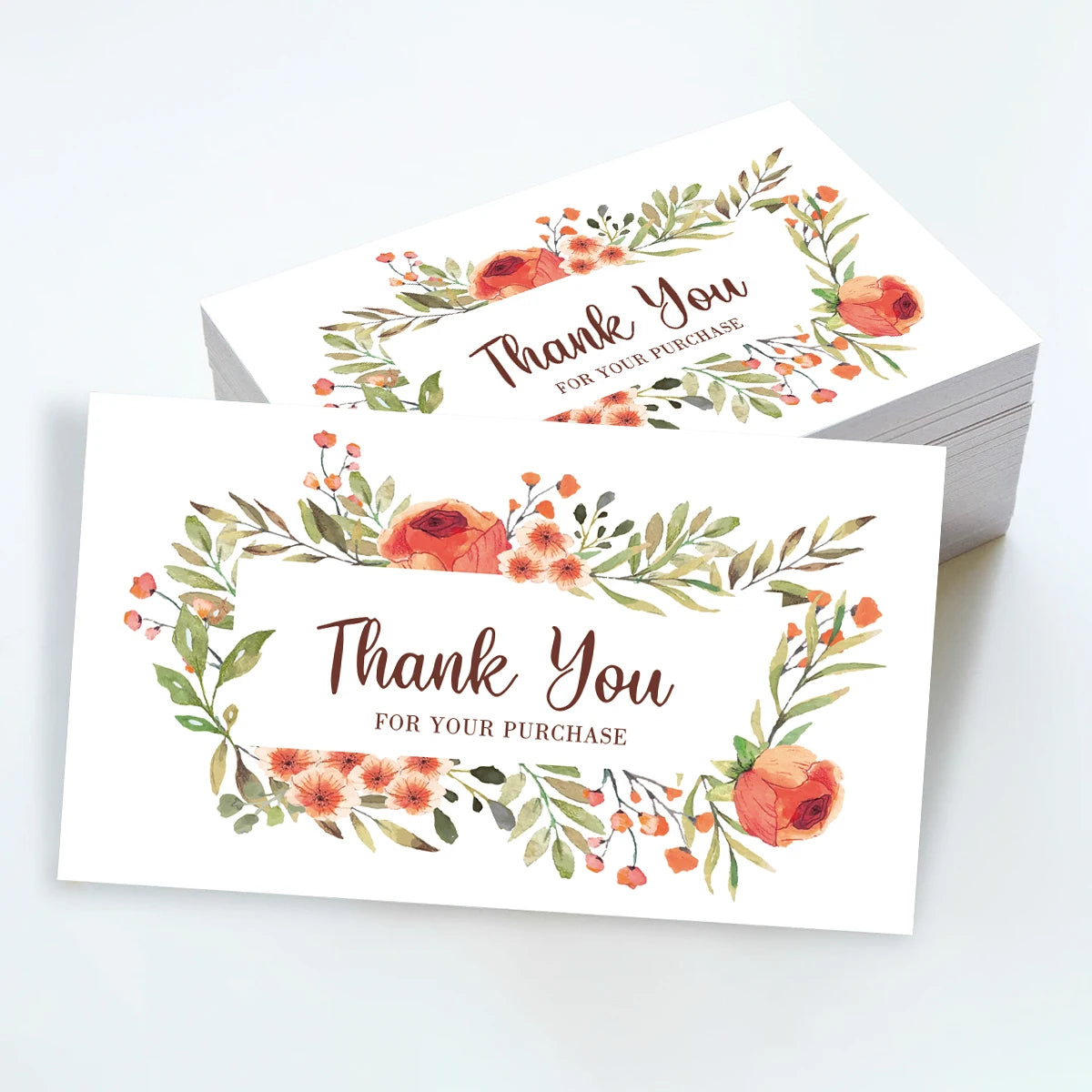 Ein Set eleganter Dankeskarten mit Aquarellrosen und Grün auf weißem Karton.