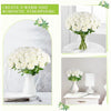 A white rose bouquet in a glass vase on a table, creating a warm and romantic atmosphere.