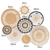 A collection of round woven straw wall hangings in various sizes and textures.