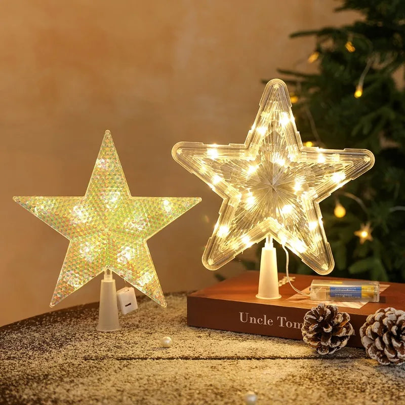 A glowing LED star shaped Christmas tree topper with warm white lights resting on a wooden surface.