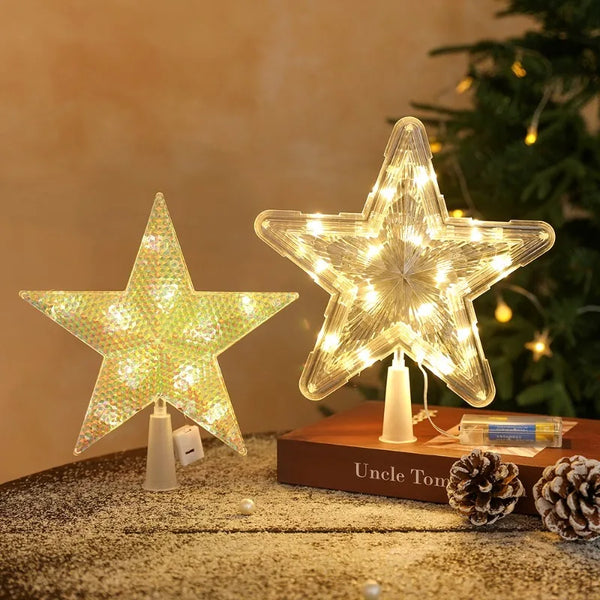 A glowing LED star shaped Christmas tree topper with warm white lights resting on a wooden surface.