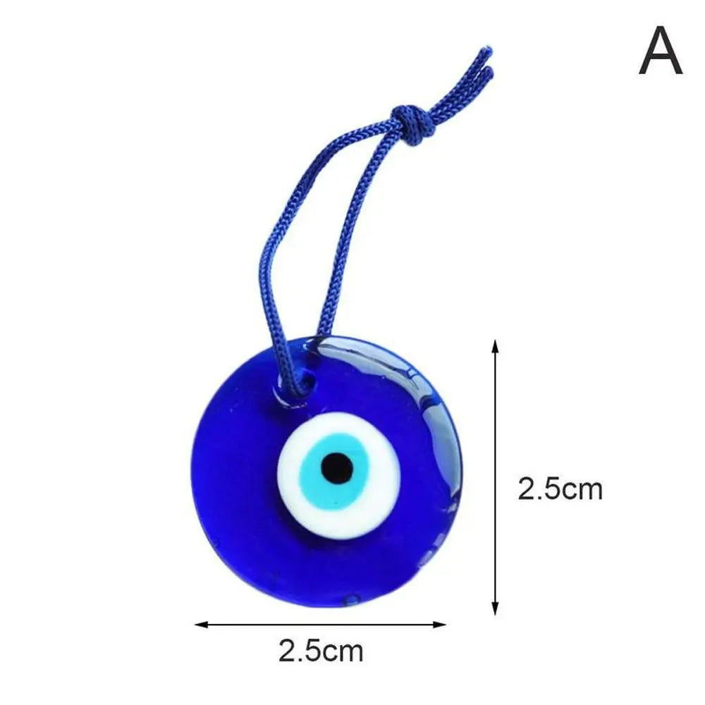A blue glass evil eye amulet pendant with a string for suspension.