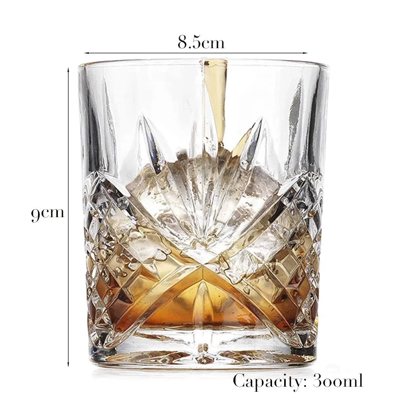 A clear whiskey glass with a heavy base and faceted design, showing its dimensions and capacity.