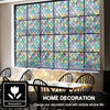 A large window covered with colorful rainbow stained glass film in a grid pattern, displayed indoors.