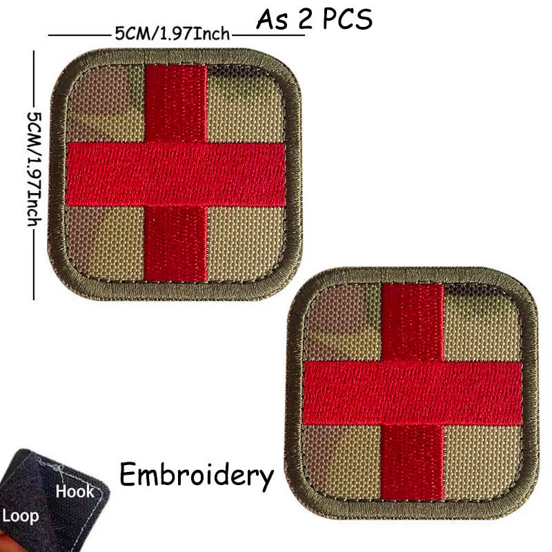 Two embroidered medical cross tactical morale patches, one in olive green and one in red.