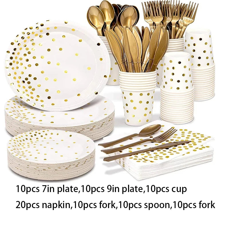 A set of gold polka dot disposable party tableware including plates, cups, napkins, forks, and spoons.