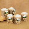 A set of rustic wooden tealight candle holders wrapped in twine with engraved thank you messages.