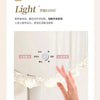 A hand is adjusting a white LED vanity mirror with adjustable light settings in a bathroom setting.